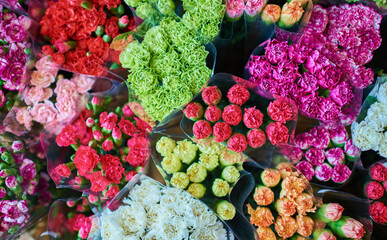 Beautiful bouquets of mixed flowers in a flower shop. A bright mix of flowers. Background on full screen. Handsome fresh bouquets. Flowers delivery. Floral shop concept. Selective focus.