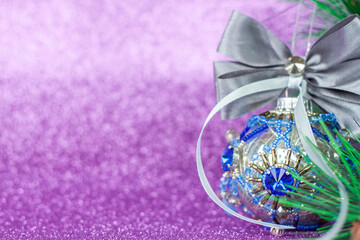 Beautiful and very shiny bead. Toy for the Christmas tree. Christmas balloon on a purple background. New year greetings, postcards, calendar.
