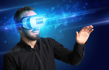 Businessman looking through Virtual Reality glasses with CYBER CRIME inscription, cyber security concept