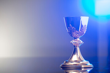 Catholic religion concept background. Golden chalice, place for text.