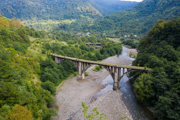 Old miners' railway bridge in the mountains and forests. Tkuarchal, Akarmara, Abkhazia, Georgia