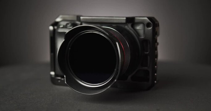 rotating photo camera over black background