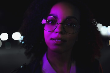 Black  girl portrait in night city lights