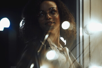 Black  girl portrait in night city lights