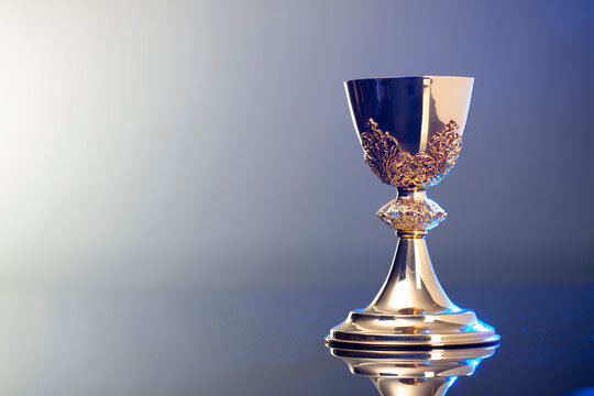 Catholic religion concept background. Golden chalice, place for text.
