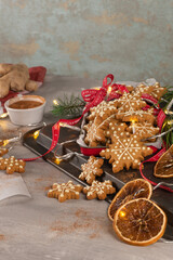 Gingerbread cookies with icing on countertop with festive lights. Christmas cookies snow flakes decorated with sugar frosting. Christmas holiday tradition and advent