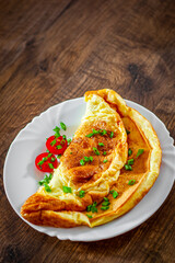 omelette in a white plate on wooden table