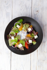 Greek salad. salad, tomatoes, feta cheese, cucumbers, olives.