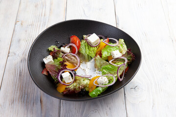 Greek salad. salad, tomatoes, feta cheese, cucumbers, olives.