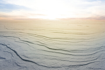 winter snowbound plain in a light of evening sun