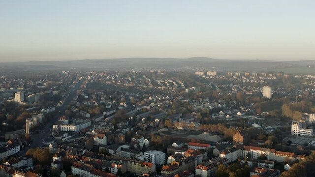 Drone shot of the cityscape landscape of Kassel in beautiuful soft sunlight and covered in fog. Typical german urban living, Germany, Europe.