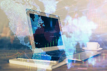 Financial chart drawing and table with computer on background. Multi exposure. Concept of international markets.