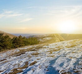 mount slope covered by a snow at the sunset