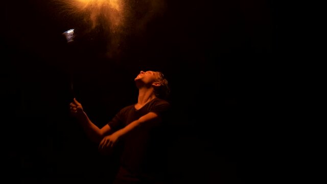 Guy artist fire show breathing fire in an abandoned place at night. Slow motion