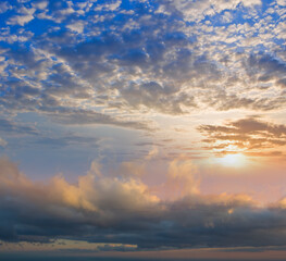 Fototapeta na wymiar dramatic sunset over a dense cloudy sky