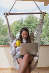 Woman using laptop while sitting outdoors