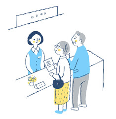 受付窓口　受付係の女性とシニア夫婦