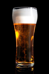  fresh beer in a beautiful tall glass on a black background