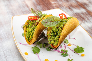 Mexican tacos. With pork, pepper and guacomole. Mexican traditional dish