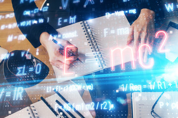 Science formula hologram over woman's hands taking notes background. Concept of study. Double exposure