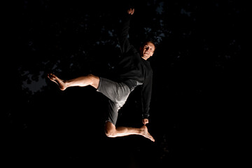 Fototapeta na wymiar Man having fun and jump high in the air