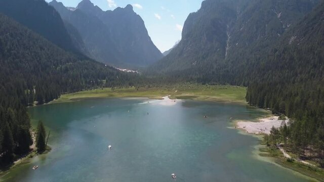 Summer holiday, green lake in the mountains in Europe at Lago di Dobbiaca next to hotel Baur Al Lago