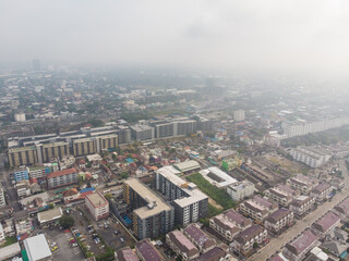 Fototapeta premium Aerial view city building with air pollution remains at hazardous levels PM 2.5 pollutants