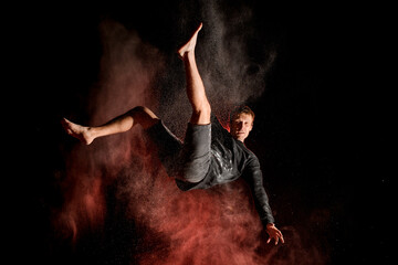 view on guy jumping high in the air at dark