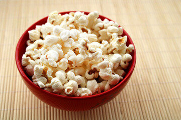 Popcorn in a bowl on a wooden table