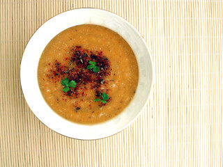 Bowl of lentil soup on table, top view
