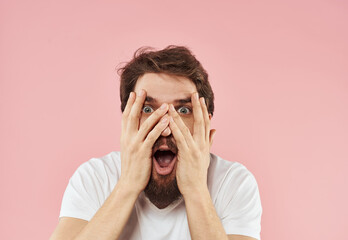 Man grimaces on pink background emotions model irritability