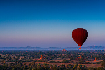 Sunset many hot air balloon with stupas in Bagan, Myanmar. Bagan is an ancient with many pagoda of historic buddhist temples and stupas. space for text.