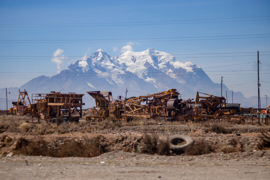 Abandoned machinery near the city of la paz with mount illimani in the background  - Bolivia