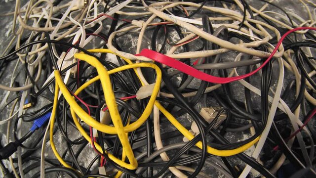 Tangled cables, messy cables. Untangleable, network, computer, electric, monitor cables. Computer service, data transmission.
