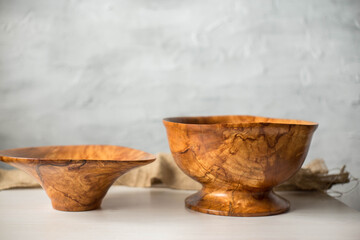 Wooden plate on a white table. National dishes. Crockery made from natural materials. Wood texture