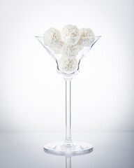 truffles white chocolate  covered with coconut flakes on white background