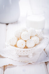 truffles white chocolate  covered with coconut flakes on white background