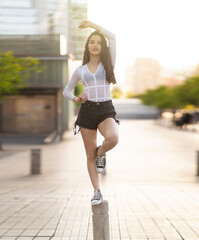 teen girl standing balance in a feet in downtown