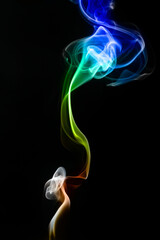 multicolored smoke of green and blue colors on a black isolated background. Background of smoke