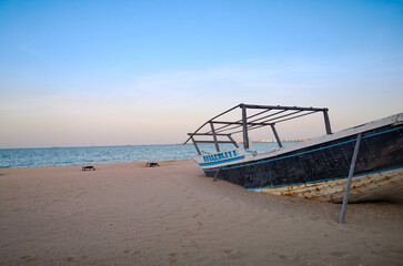 Background images of boats kept at the shore of the wakrah beach in Qatar.