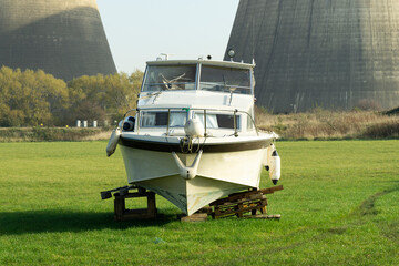 Old river cruiser boat in a field