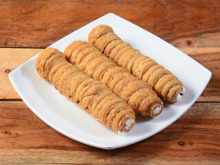 Sweet Bakery Food Puff Roll with Cream also know as Cream Roll, puff pastry is a type of sponge cake roll filled with vanilla cream,