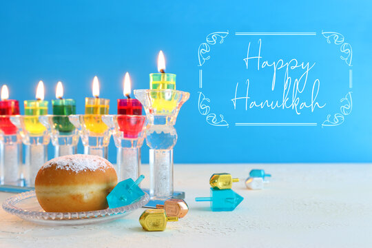image of jewish holiday Hanukkah background with crystal menorah (traditional candelabra) and oil candles