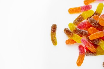 Marmalade worms on a white background. Sweets. Unhealthy food.