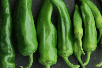 Green chili peppers on a vintage table