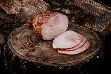 Smoked pork bacon half a piece on a wooden board, sliced ​​pork. Top view. Close up.