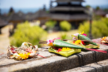 Closeup of typical Balinese pray offering baskets with in the background  Pura Besakih temple complex