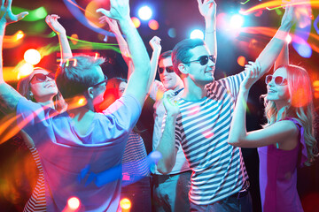 Obraz premium Group of young people having fun dancing at party.