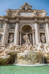 Fototapeta na wymiar The famous Fountain of Trevi in Rome with blue sky