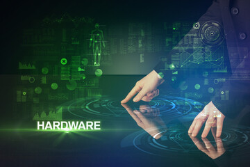 Businessman touching huge display with HARDWARE inscription, modern technology concept